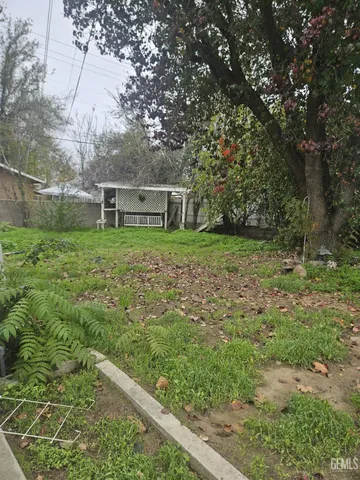 an empty room with windows and fireplace