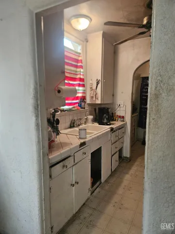 a kitchen with a sink stove and cabinets