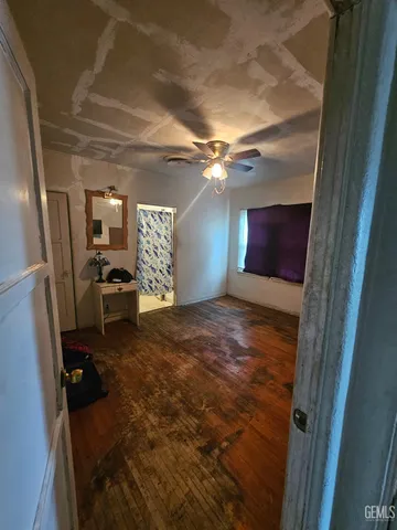 a view of a livingroom with furniture and a kitchen