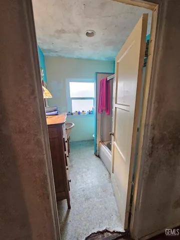 a view of a hallway with furniture