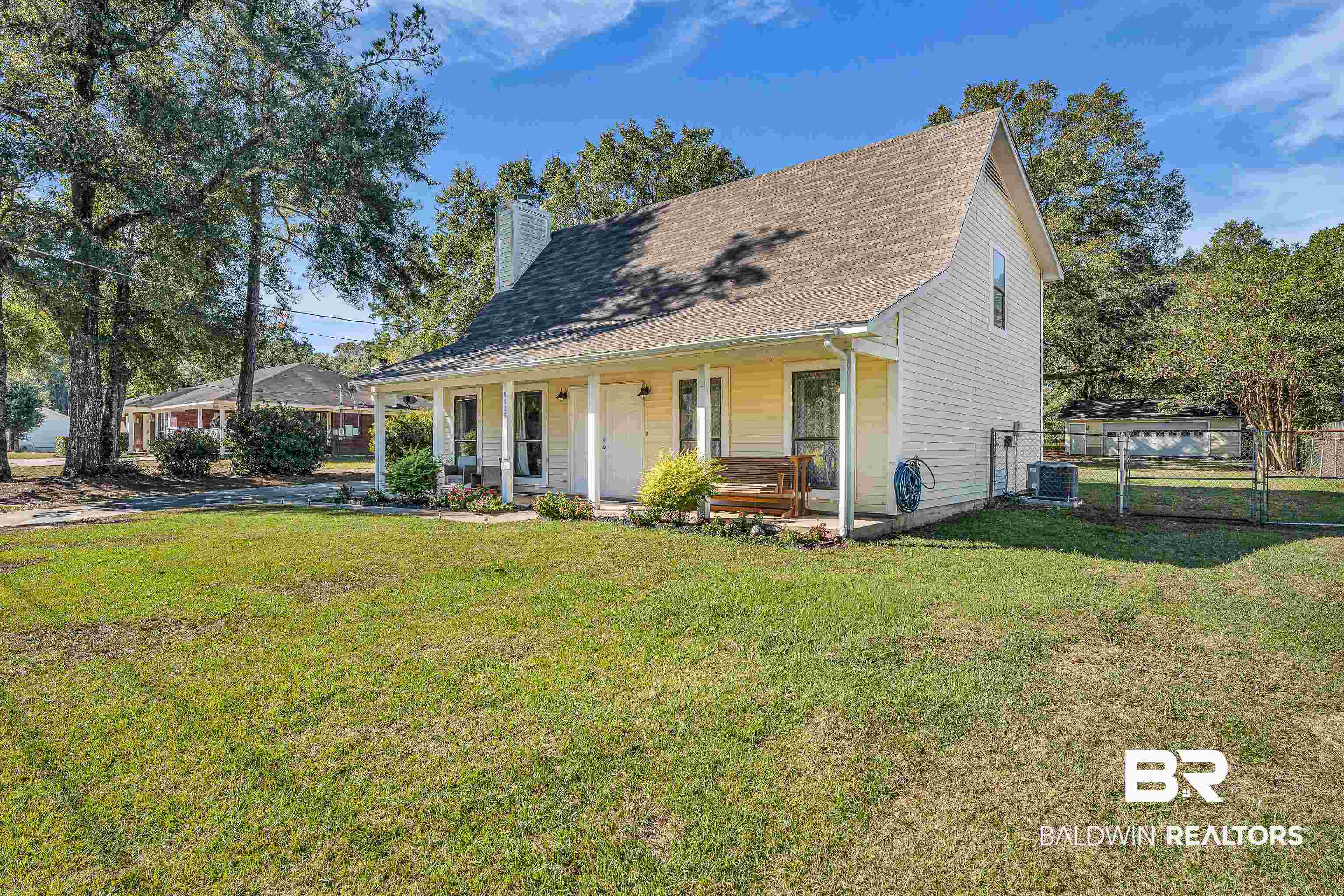 6135 Oak Cliff Drive Eight Mile, AL 36613 - Photo 3 of 30 View of front of property featuring a porch, a chimney, a shingled roof, and a gate