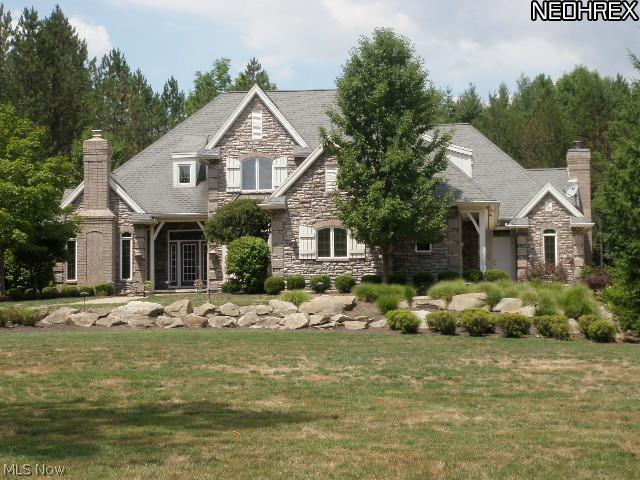 Fabulous custom designed stone and brick home on 3.4 wooded acres.