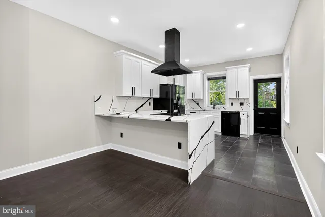 a kitchen with stainless steel appliances a sink and a hard wood floor