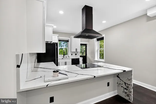 a kitchen with stainless steel appliances a sink and a table