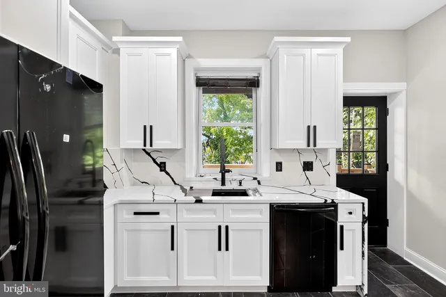 a kitchen with appliances cabinets and a sink