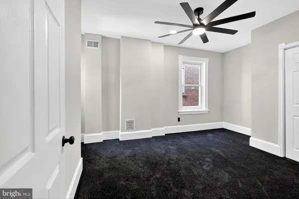 a view of an empty room with a window