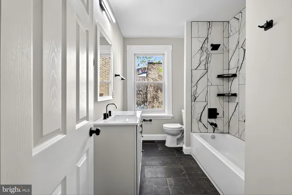 a bathroom with a sink a toilet and a bathtub