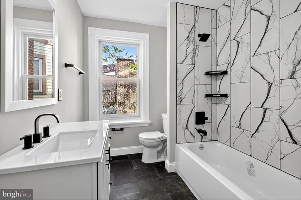 a bathroom with a sink a toilet and a bathtub