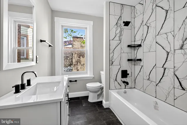 a bathroom with a sink a toilet and a bathtub