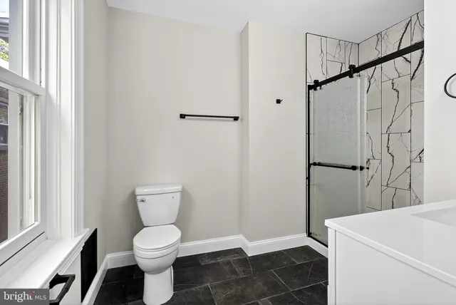 a bathroom with a toilet and a shower