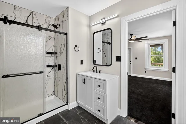 a bathroom with a double vanity sink mirror and shower