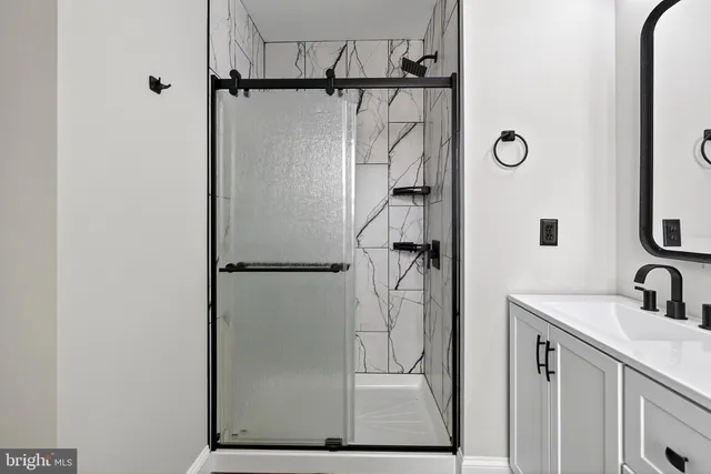 a bathroom with a shower and a sink