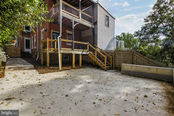 a front view of a house with wooden fence