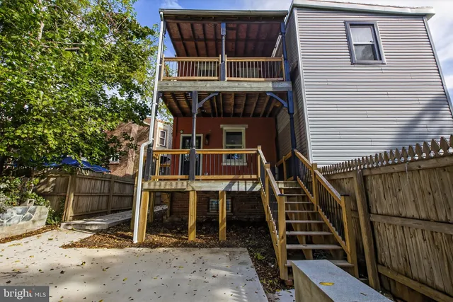 a front view of a house with wooden fence