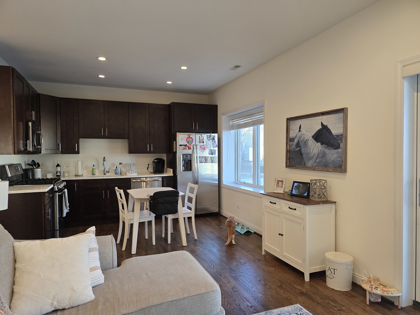 723 West 34th Street, Unit 2E Chicago, IL 60616 - Photo 3 of 9 a living room with stainless steel appliances kitchen island granite countertop furniture a kitchen island a stove a sink a refrigerator and cabinets