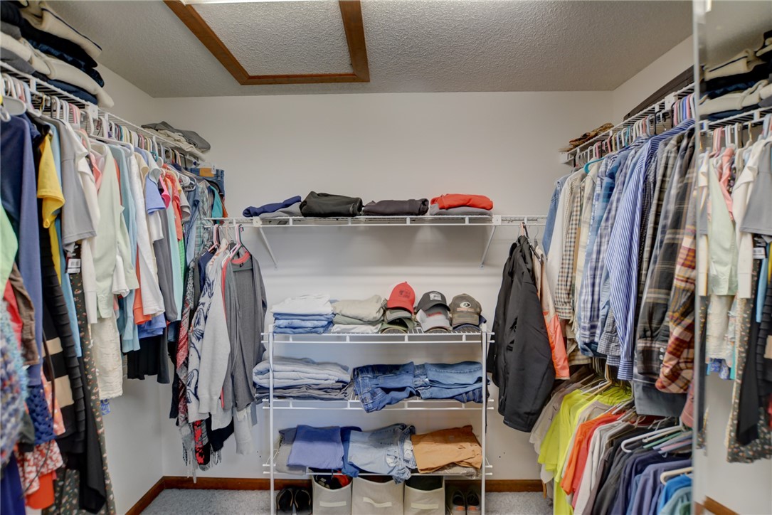 4095 West Rock Springs Road Decatur, IL 62522 - Photo 17 of 48 a view of walk in closet with clothes and shoes