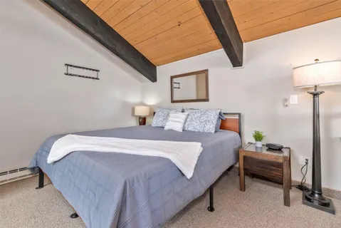 a bedroom with bed and a table