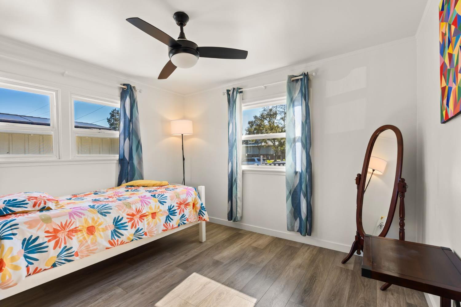 385 Sunset Avenue Oak View, CA 93022 - Photo 12 of 27 a bedroom with a bed a dresser and windows