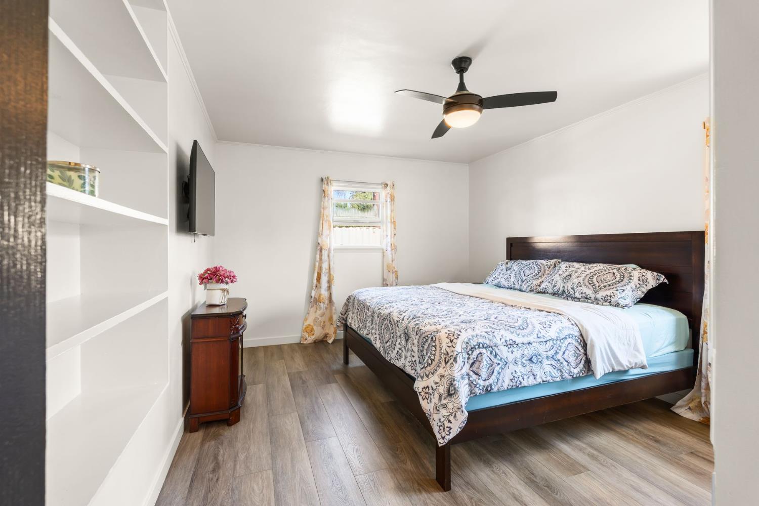 385 Sunset Avenue Oak View, CA 93022 - Photo 14 of 27 a bedroom with a bed and wooden floor