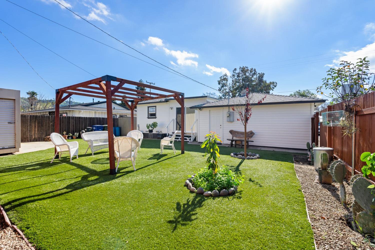 385 Sunset Avenue Oak View, CA 93022 - Photo 17 of 27 a view of a chair and table in backyard of the house
