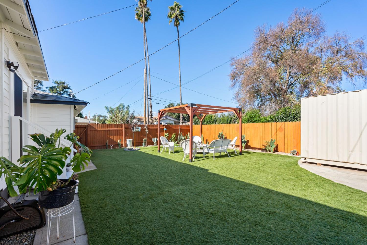 385 Sunset Avenue Oak View, CA 93022 - Photo 18 of 27 a view of a backyard with couches under an umbrella