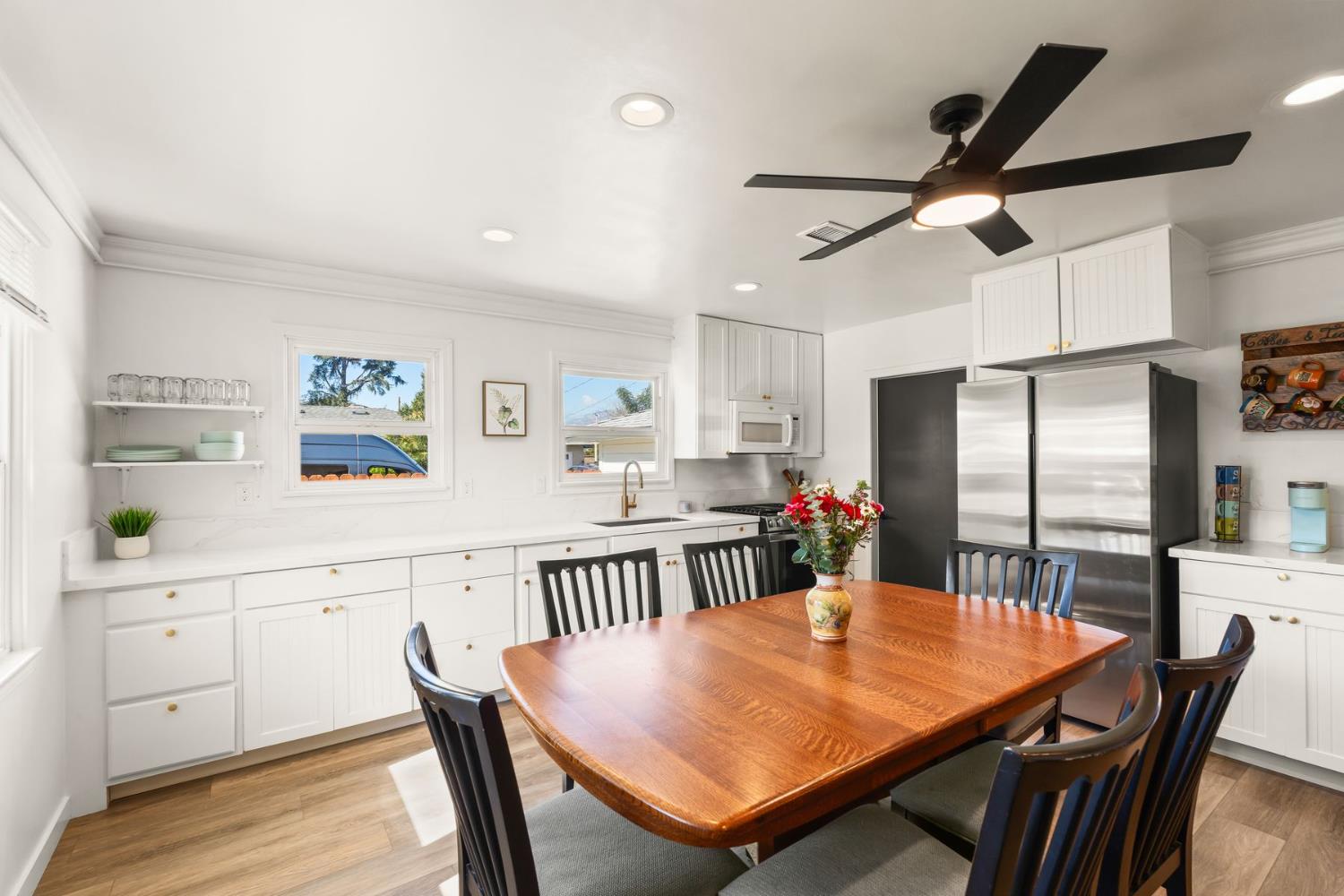 385 Sunset Avenue Oak View, CA 93022 - Photo 8 of 27 a kitchen with stainless steel appliances kitchen island granite countertop a dining table chairs and a refrigerator