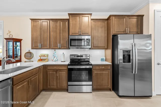 a kitchen with a refrigerator stove and sink