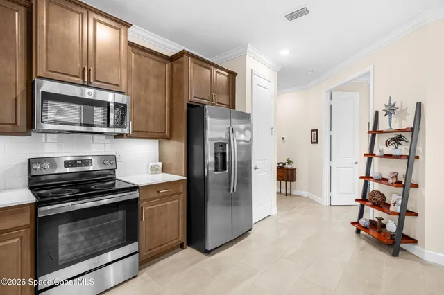 a kitchen with stainless steel appliances and cabinets