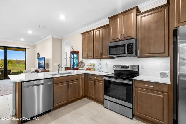 a kitchen with a sink stove and microwave