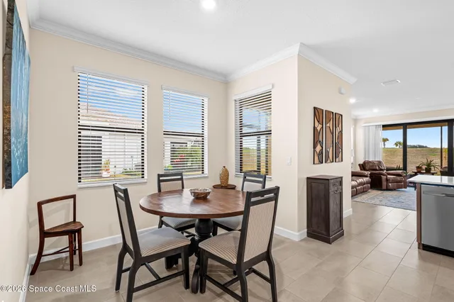 a view of a dining room with furniture and a large window