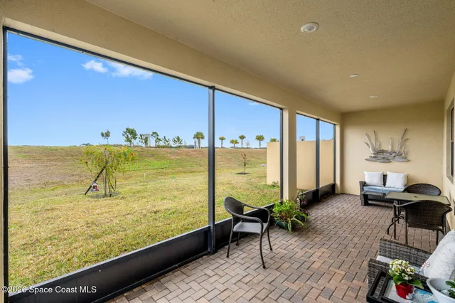 a view of a balcony with chair and table of the back