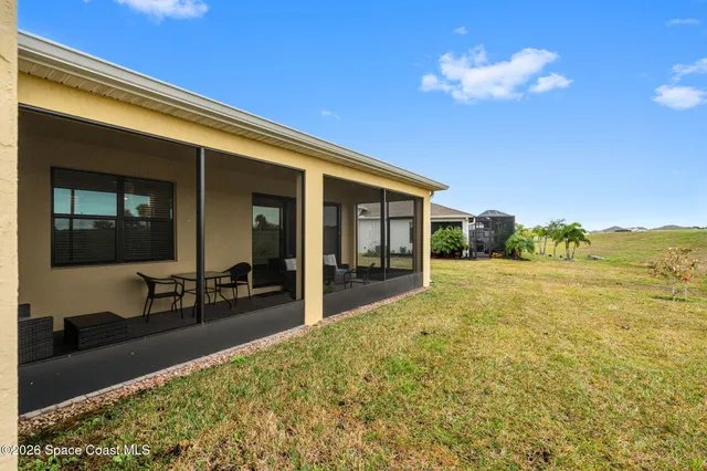 a view of a house with a backyard
