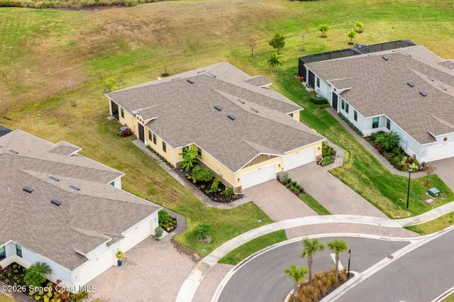 an aerial view of a house with a ocean view