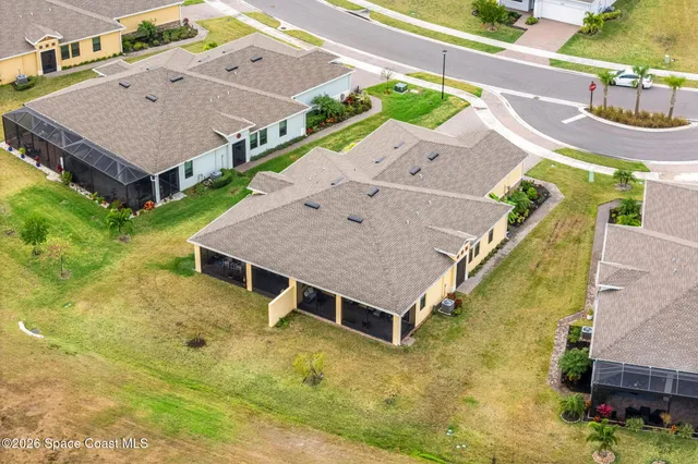 an aerial view of a house with a yard