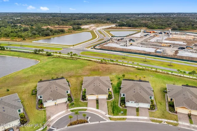 an aerial view of residential houses with outdoor space