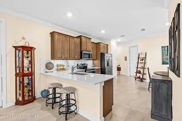 a kitchen with stainless steel appliances a refrigerator and a stove top oven