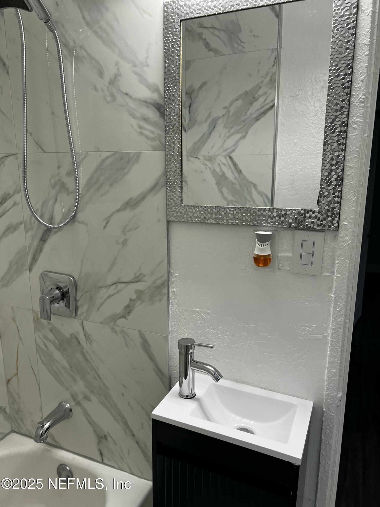 1826 Forest Hills Road Jacksonville, FL 32208 - Photo 11 of 14 a bathroom with a sink and a mirror