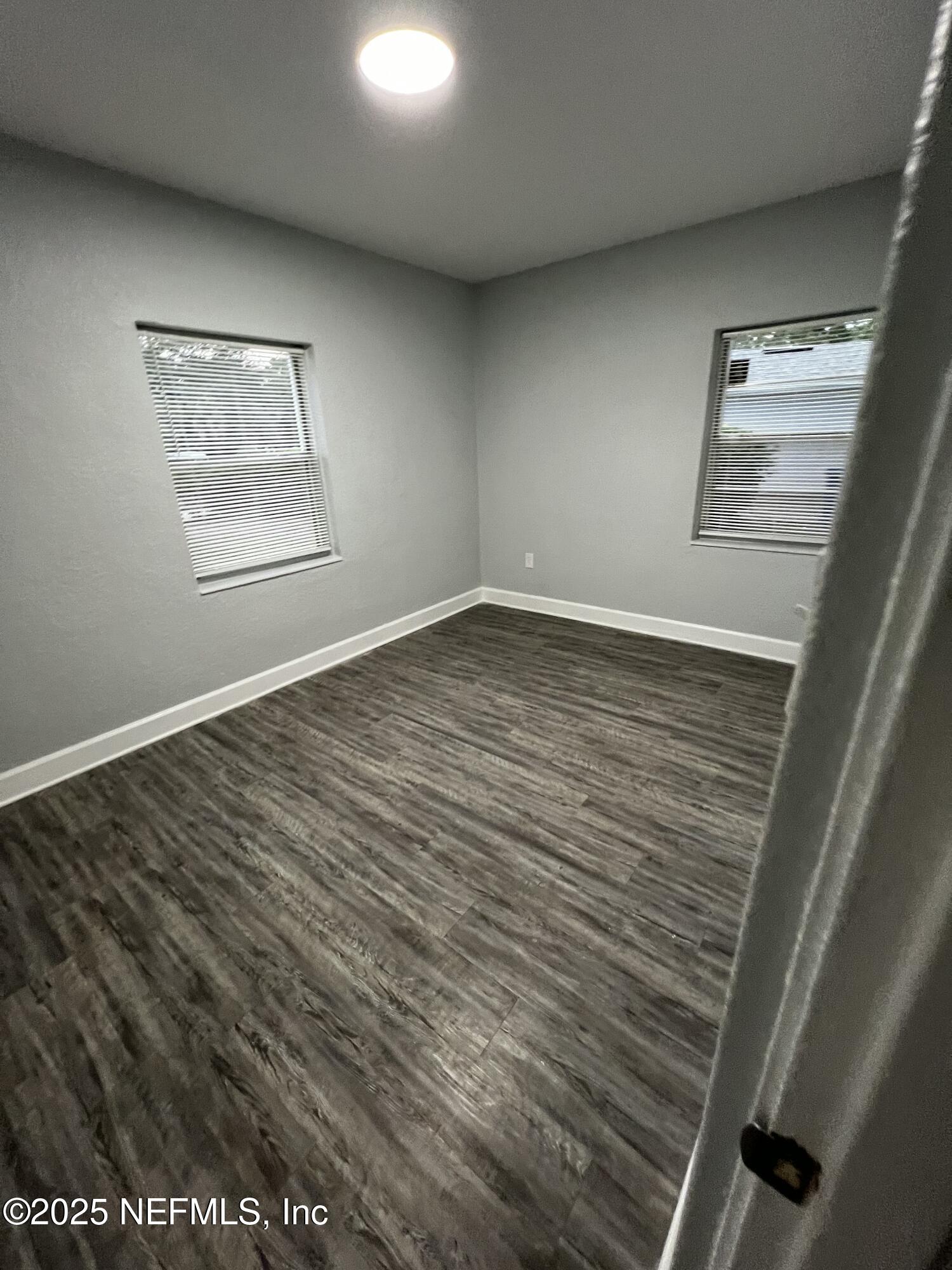1826 Forest Hills Road Jacksonville, FL 32208 - Photo 13 of 14 a view of an empty room with wooden floor and a window
