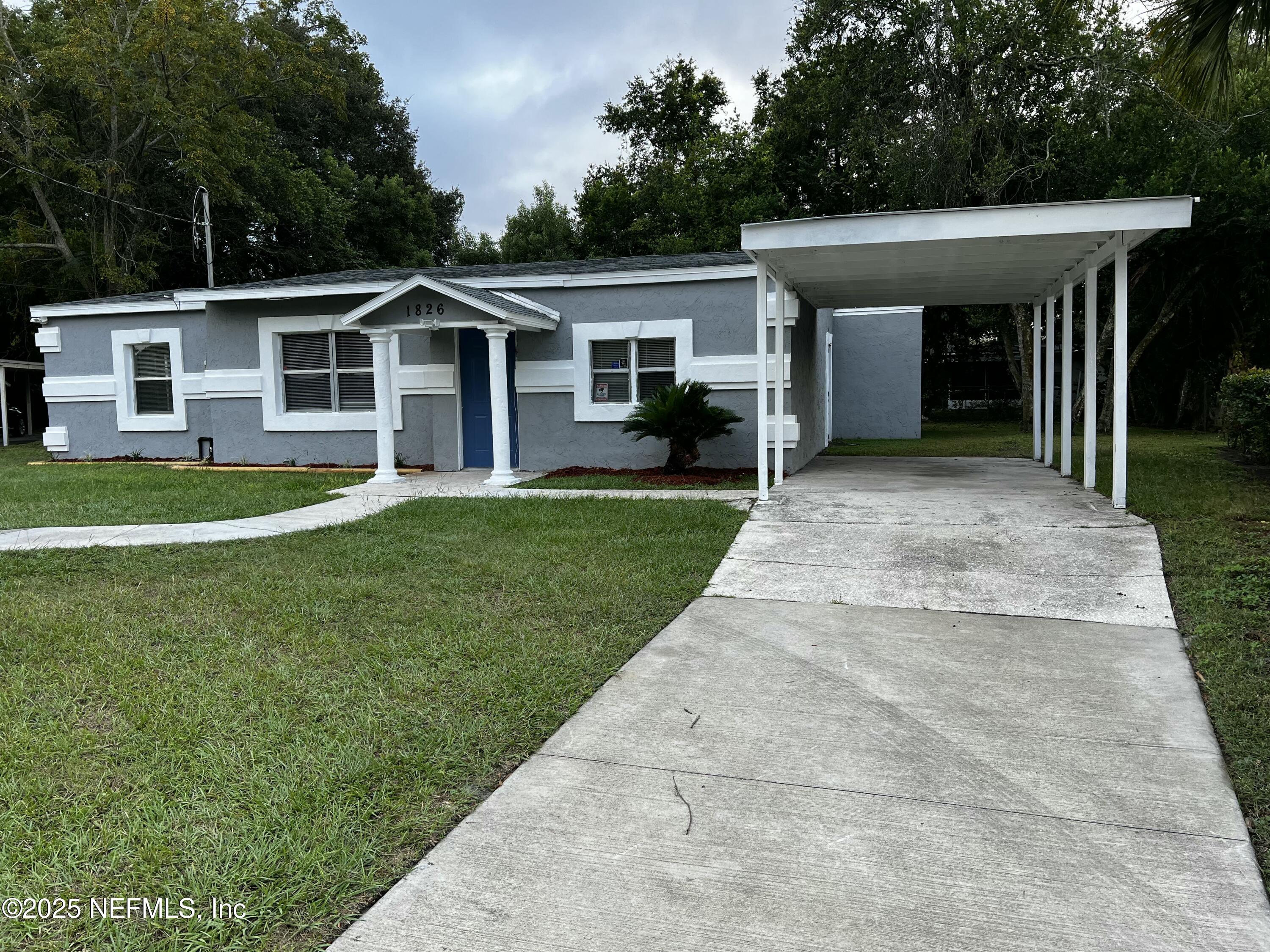 1826 Forest Hills Road Jacksonville, FL 32208 - Photo 3 of 14 a front view of a house with a yard and trees