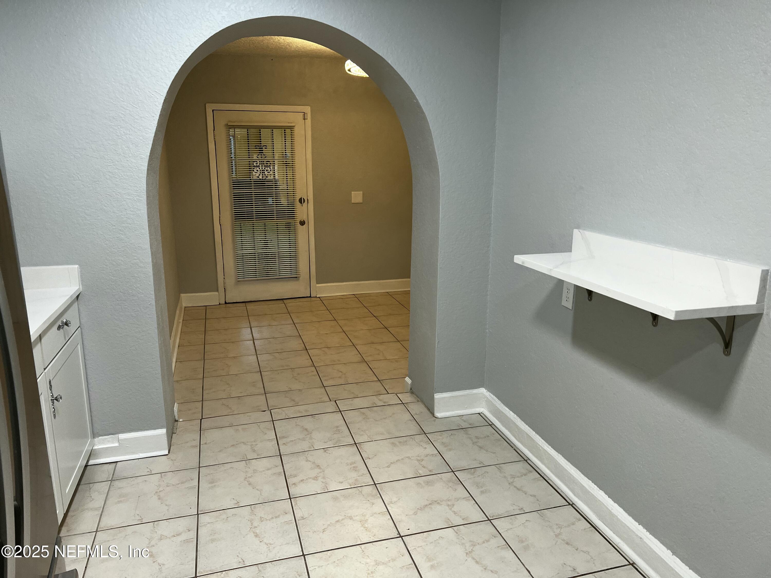 1826 Forest Hills Road Jacksonville, FL 32208 - Photo 4 of 14 a view of a hallway with wooden floor and a bathroom