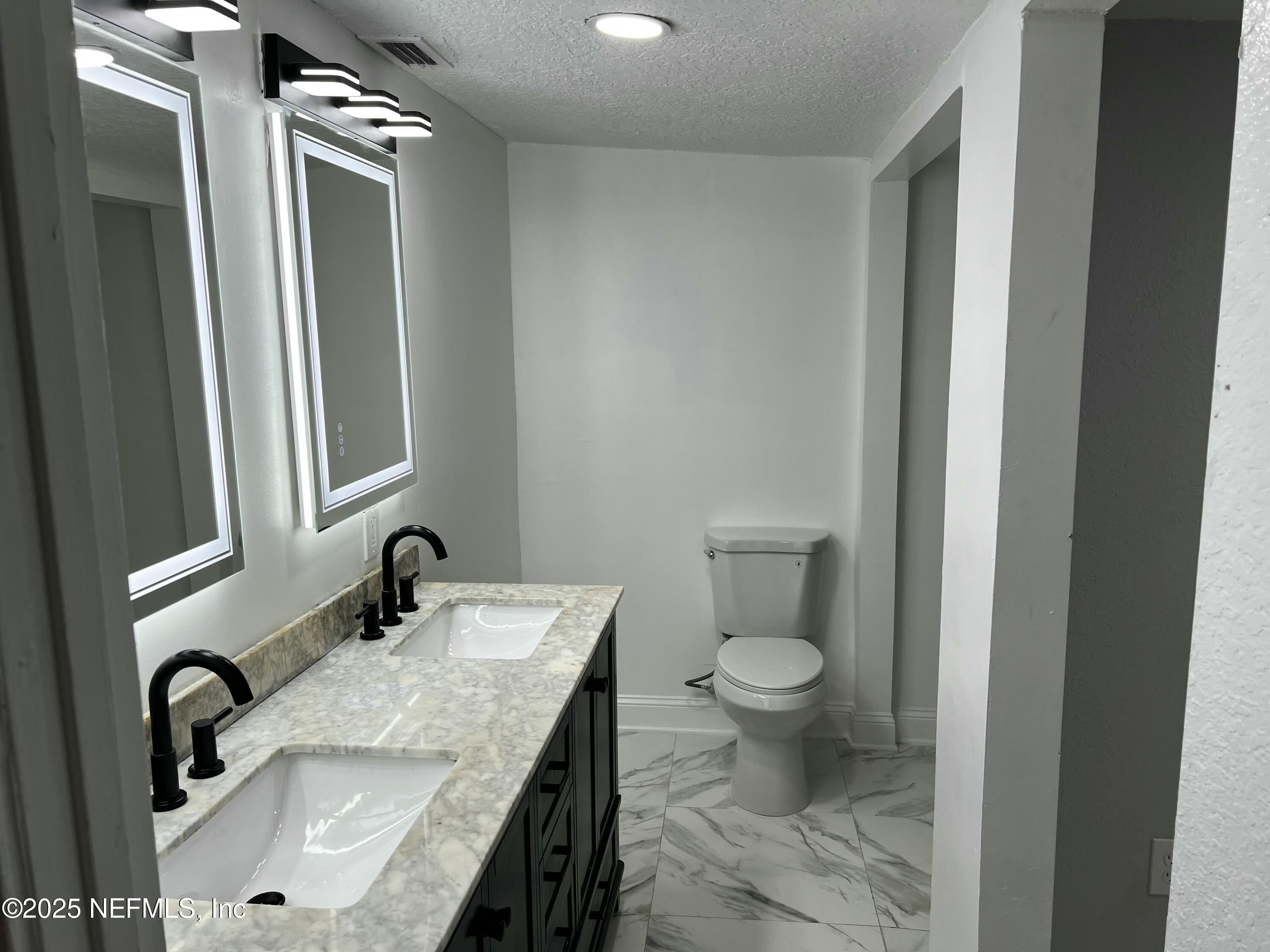 1826 Forest Hills Road Jacksonville, FL 32208 - Photo 6 of 14 a bathroom with a sink toilet and mirror
