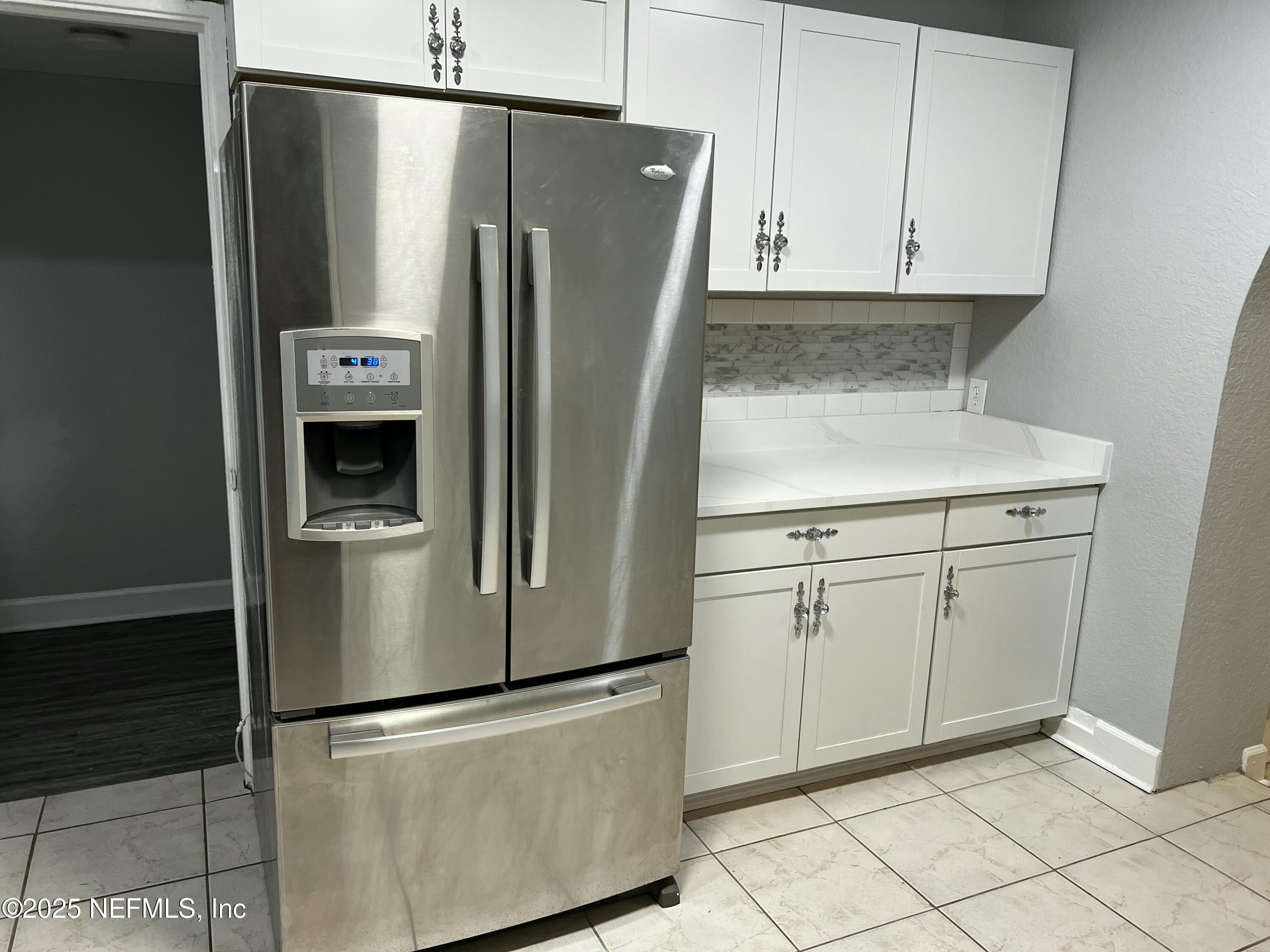 1826 Forest Hills Road Jacksonville, FL 32208 - Photo 7 of 14 a view of a refrigerator in kitchen and cabinets