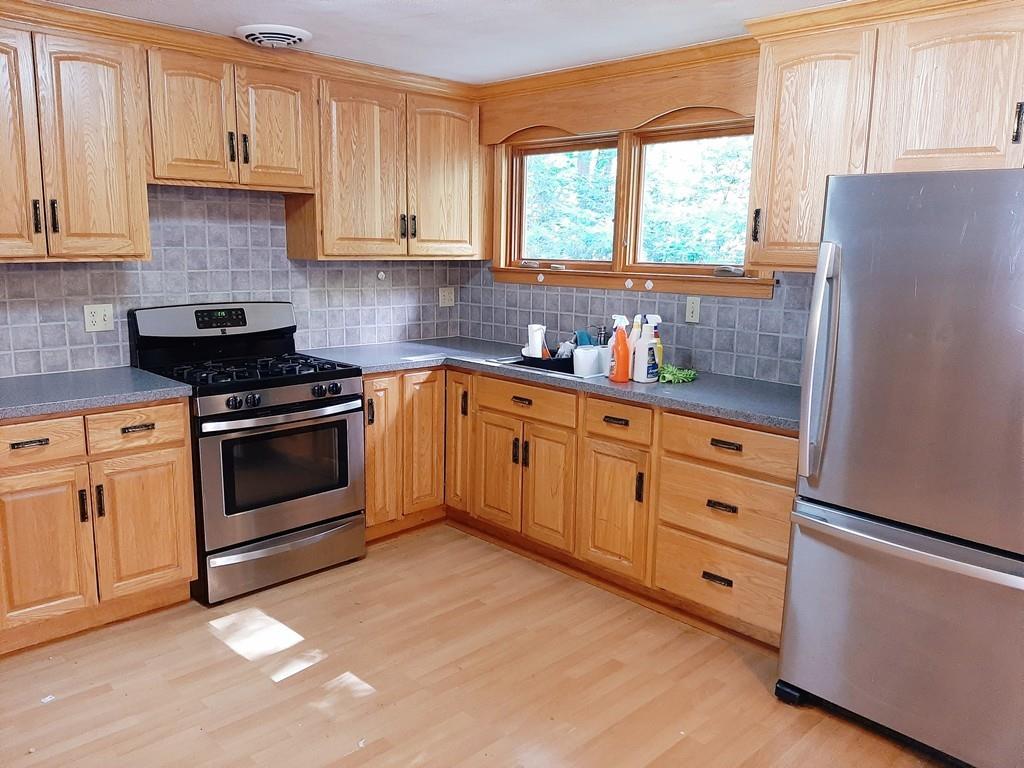 83 Berwick Road Longmeadow, MA 01106 - Photo 4 of 10 a kitchen with granite countertop white cabinets and white appliances