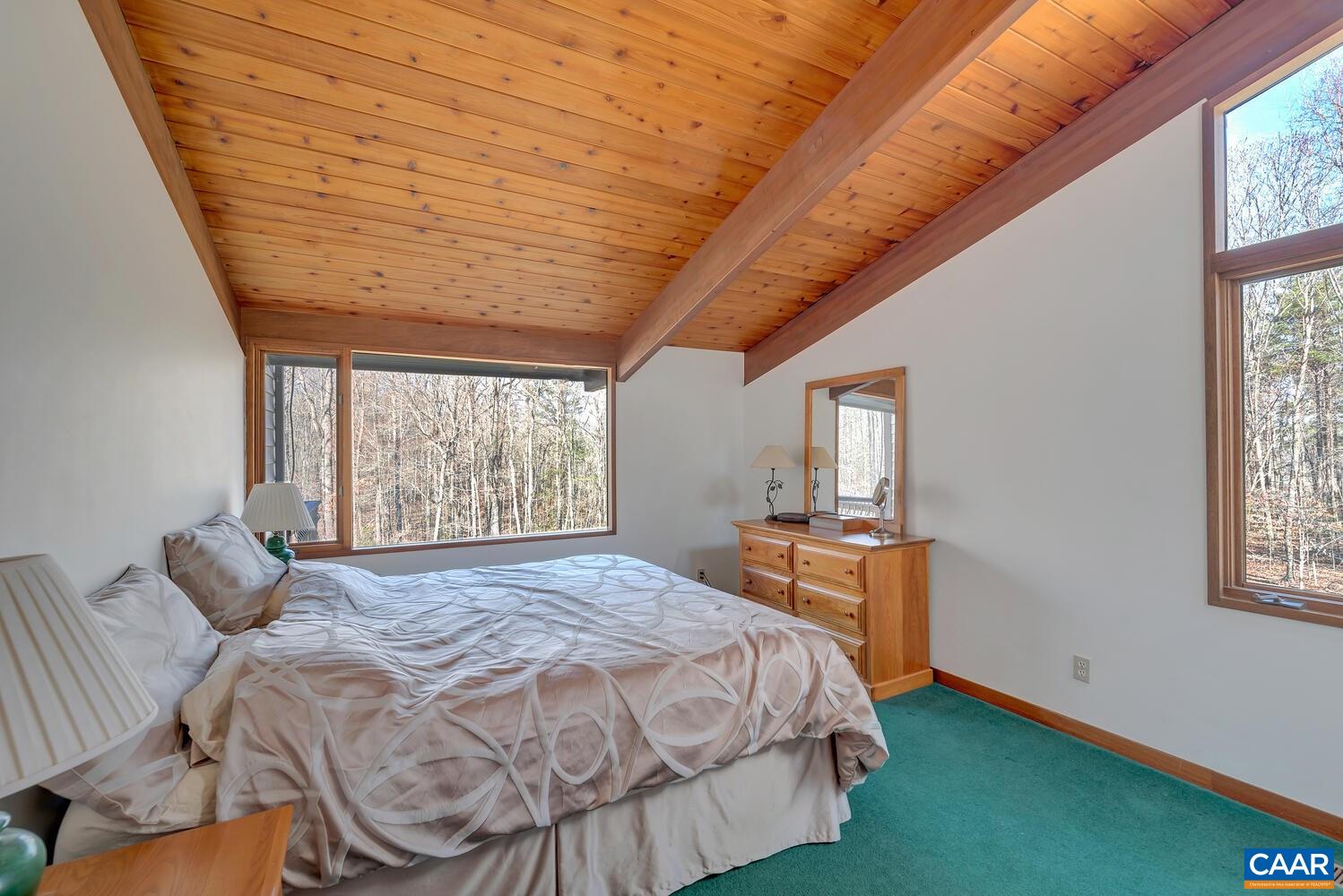 2706 Paddock Wood Road Keswick, VA 22947 - Photo 18 of 42 a bed sitting in a bedroom next to a window