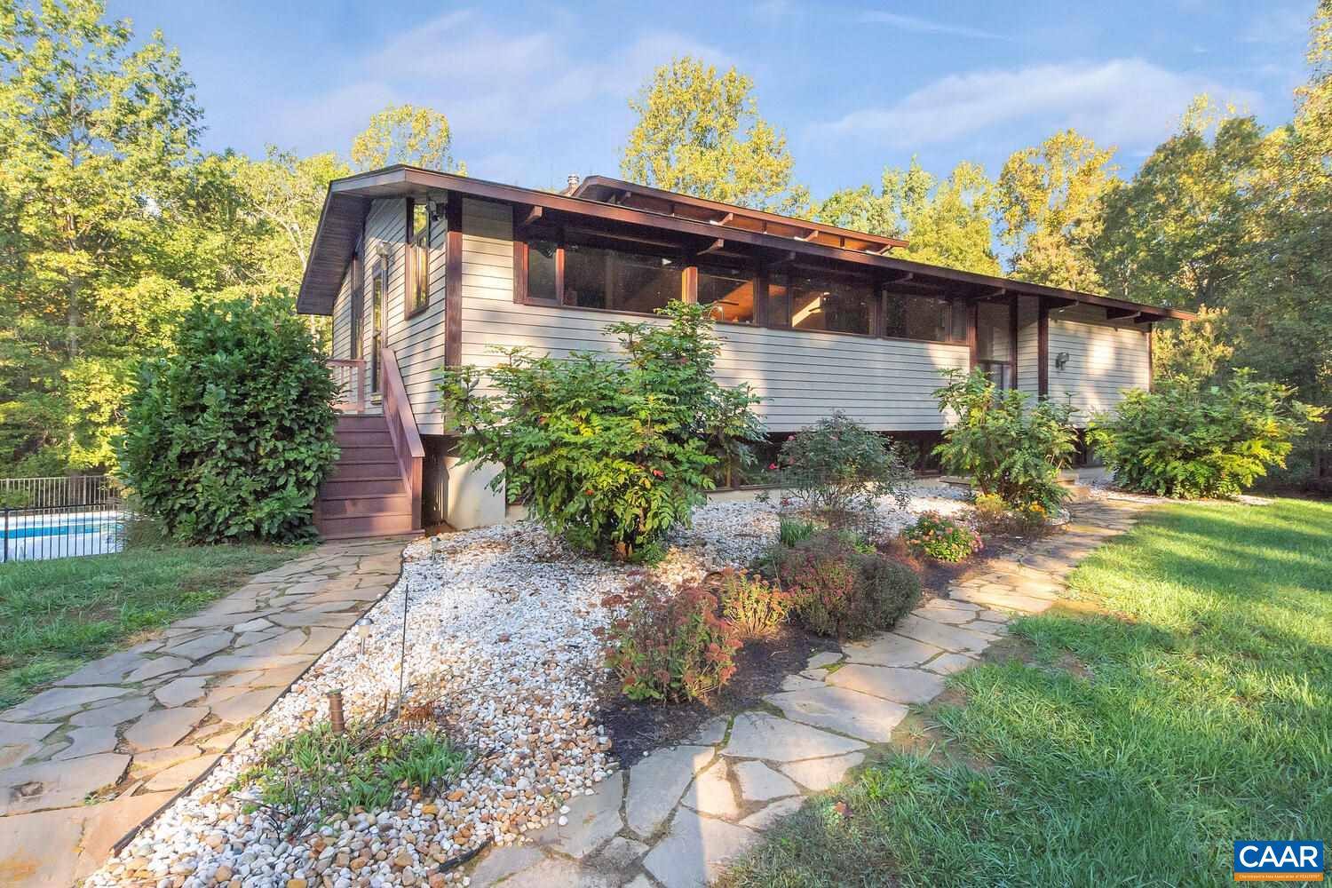 2706 Paddock Wood Road Keswick, VA 22947 - Photo 2 of 42 a front view of a house with garden