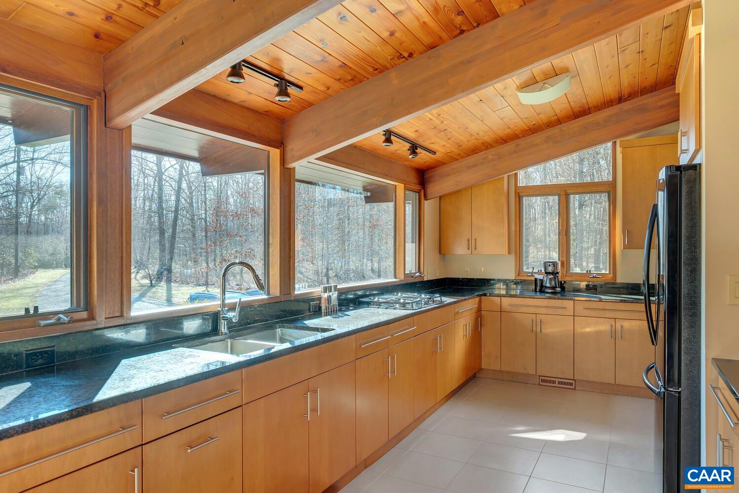2706 Paddock Wood Road Keswick, VA 22947 - Photo 25 of 42 a large kitchen with a large window and stainless steel appliances