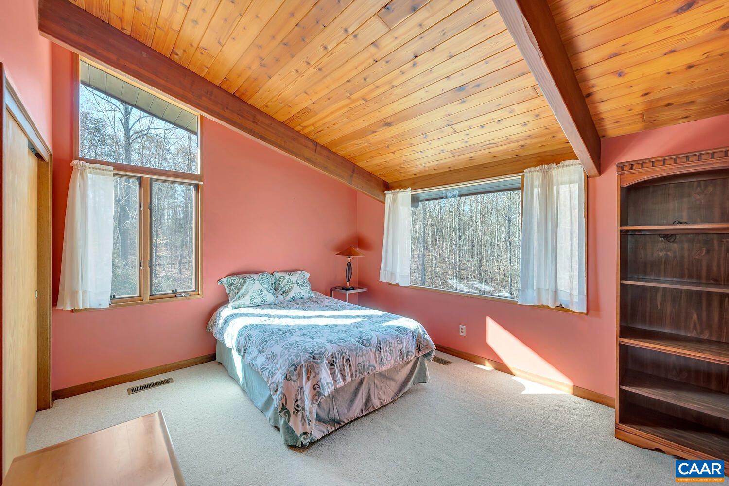 2706 Paddock Wood Road Keswick, VA 22947 - Photo 27 of 42 a bedroom with a bed and wooden floor