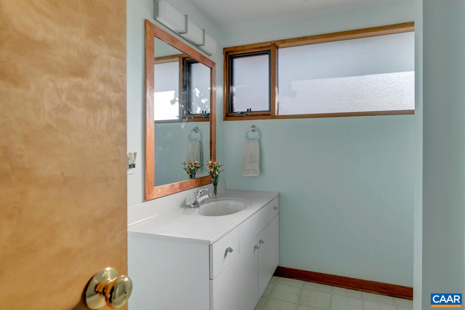 2706 Paddock Wood Road Keswick, VA 22947 - Photo 30 of 42 a bathroom with a sink and a mirror