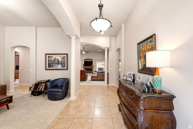 1609 East 10 S Street St. George, UT 84790 - Photo 9 of 68 Entryway with tile flooring, a decorative ceiling light fixture, arched doorways, and architectural columns