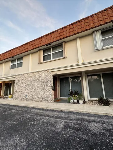 a view of a house with more windows and plants